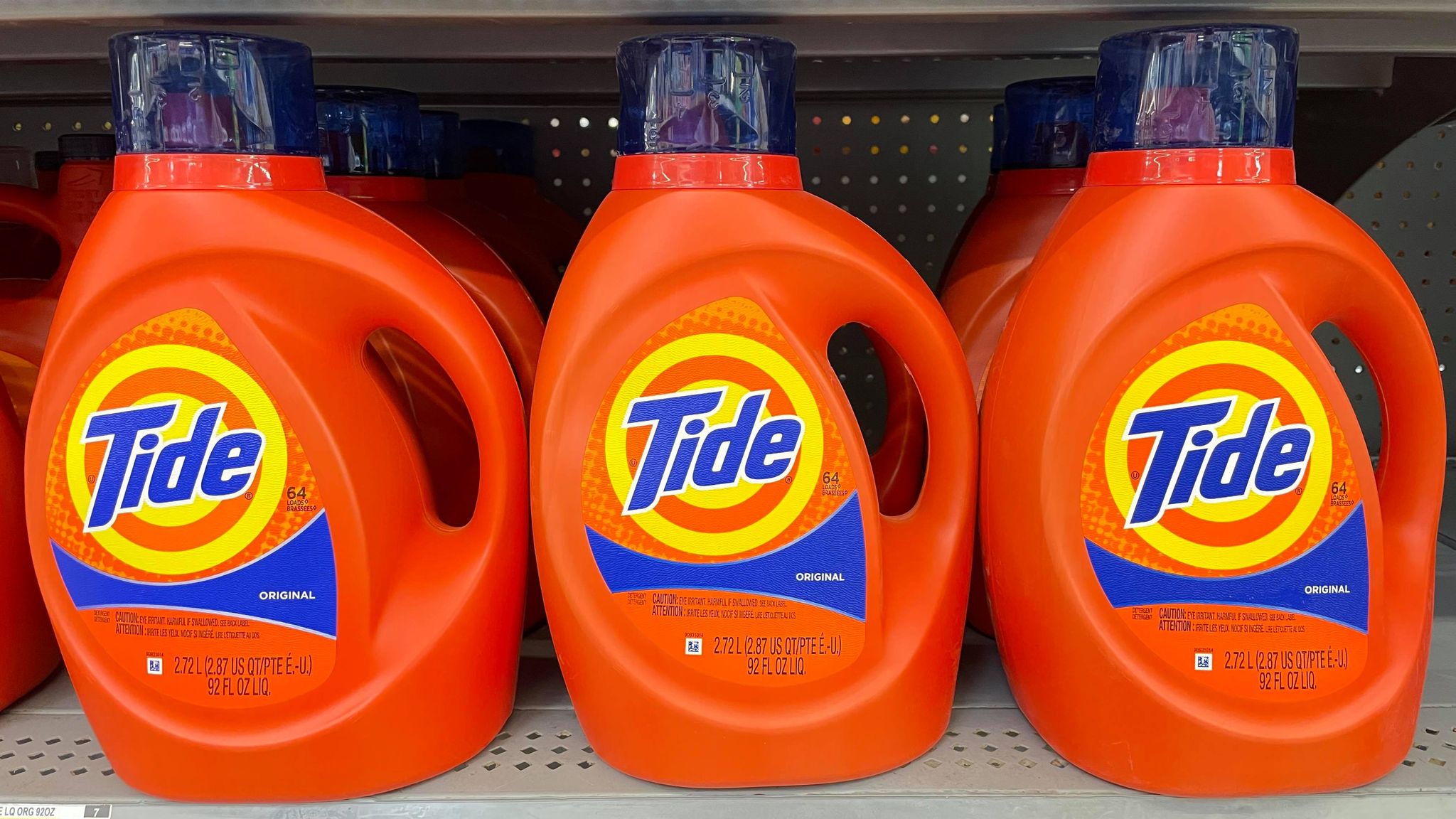 three bottles of tide detergent