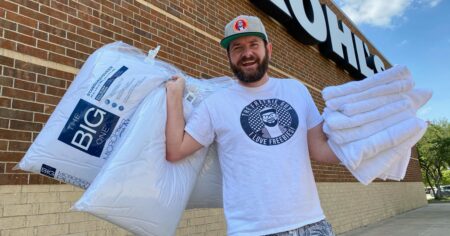 man holding pillows and towels