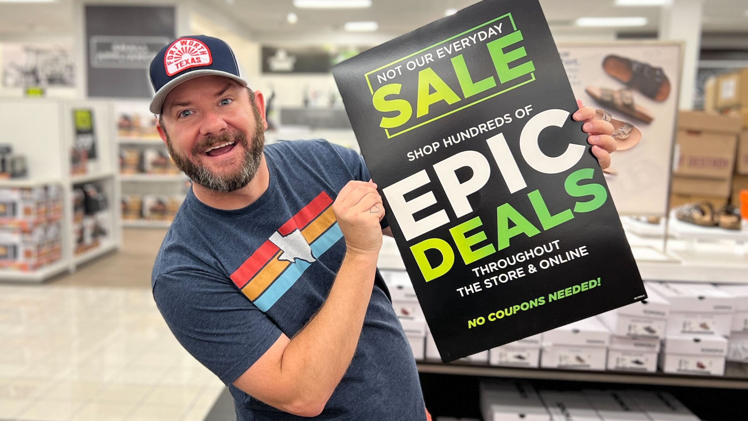 Kendall holding an Epic Deals sign in Kohl's