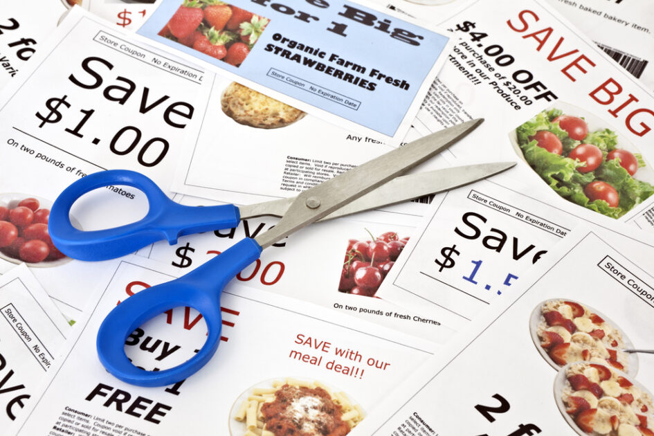 pile of coupons with scissors on top of them