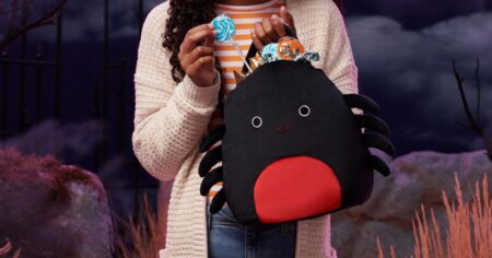 girl holding a Squishmallow treat pail