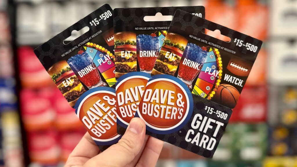 hand holding dave & busters gift cards 