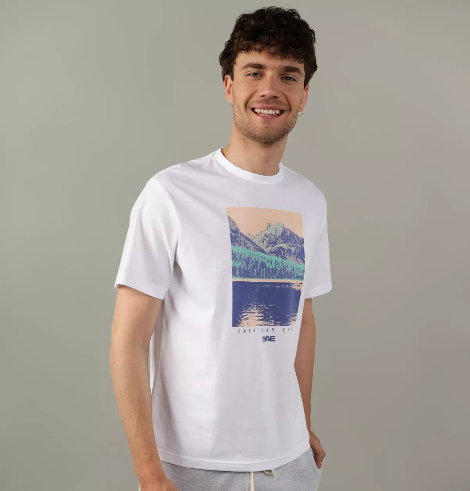 AE Graphic T Shirt man smiling at the camera wearing a white graphic tee