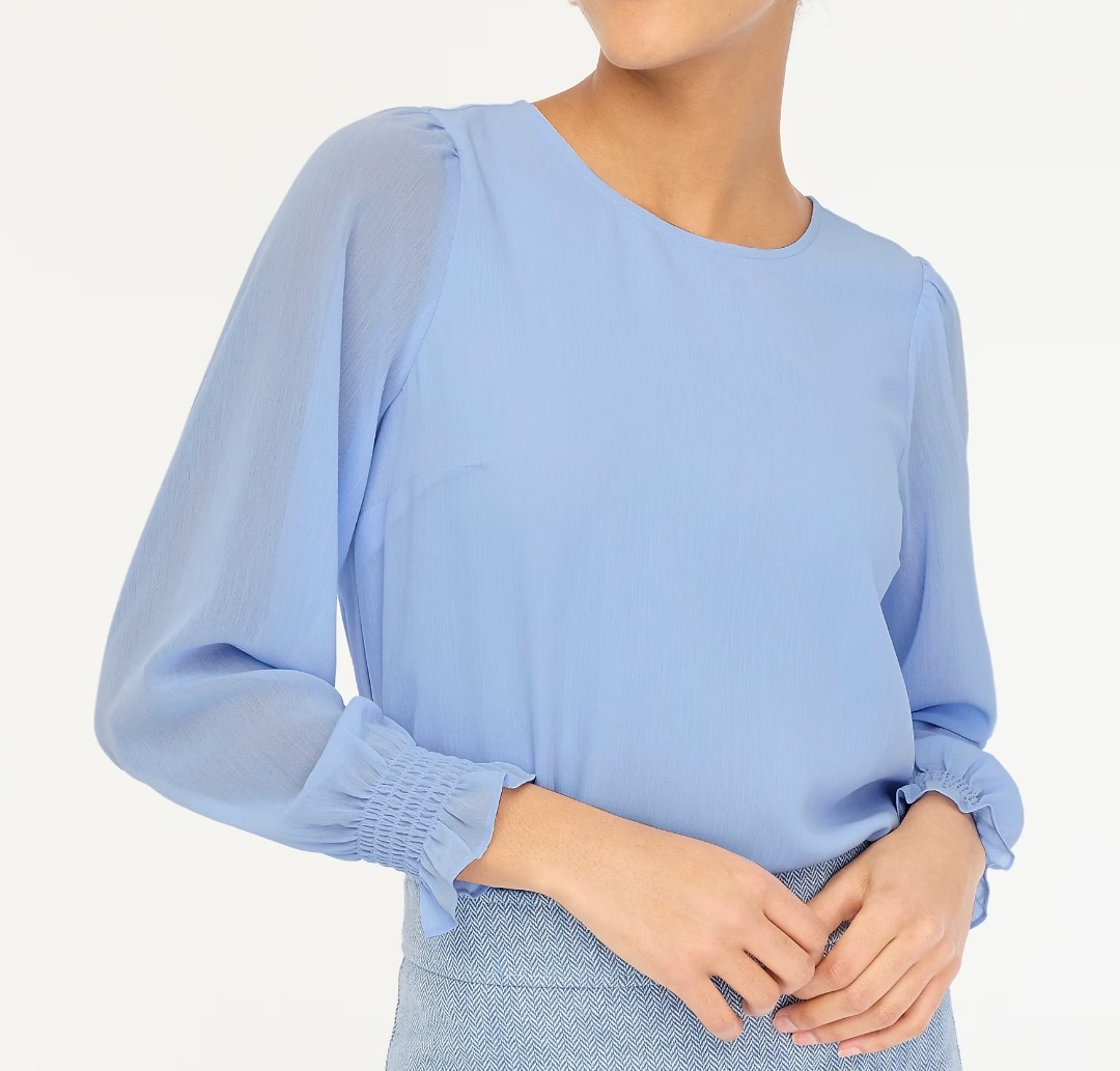 woman in a blue long-sleeved top