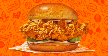 popeyes chicken sandwich with orange background
