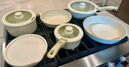 Set of Carote pans and lids on a gas range on display