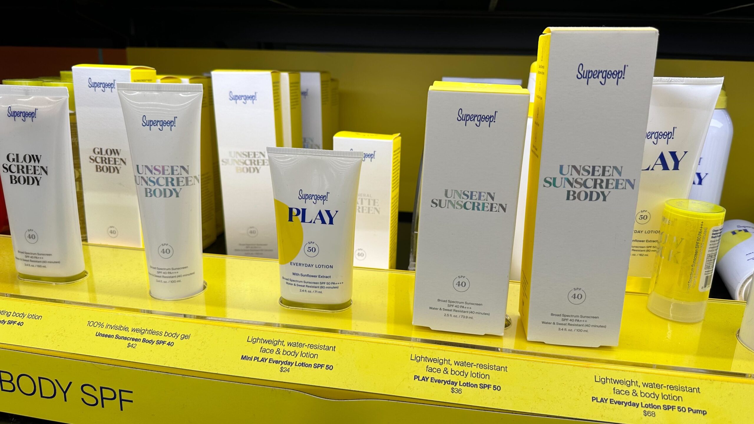 row of Supergoop products on a shelf