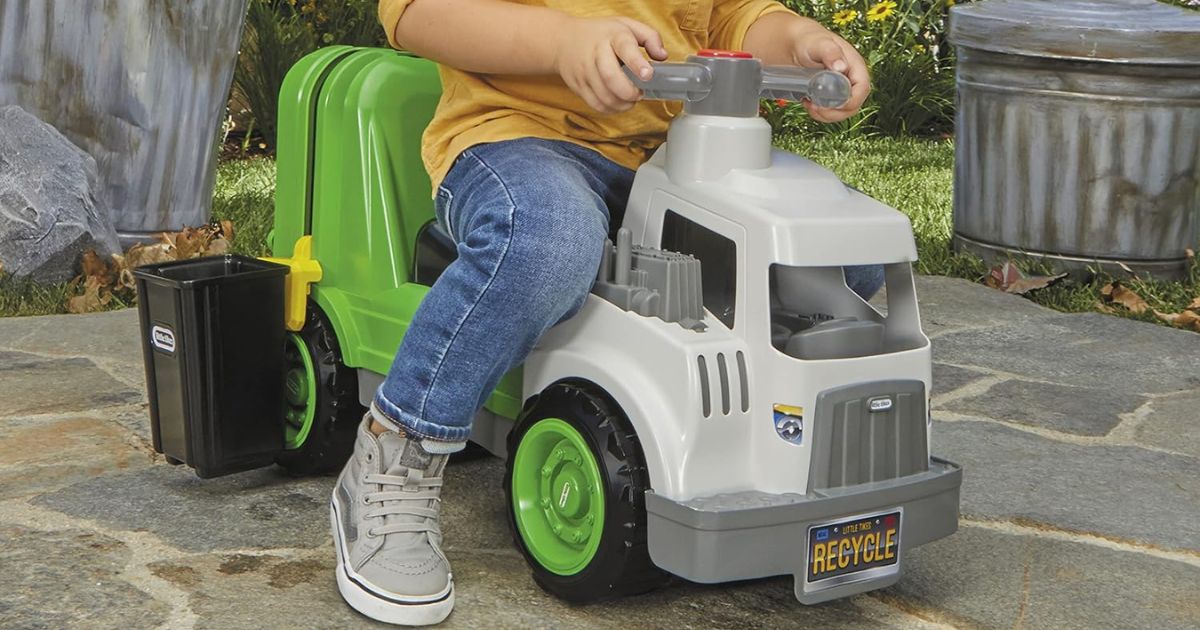Little Tikes Garbage Truck boy riding on a toy garbage truck