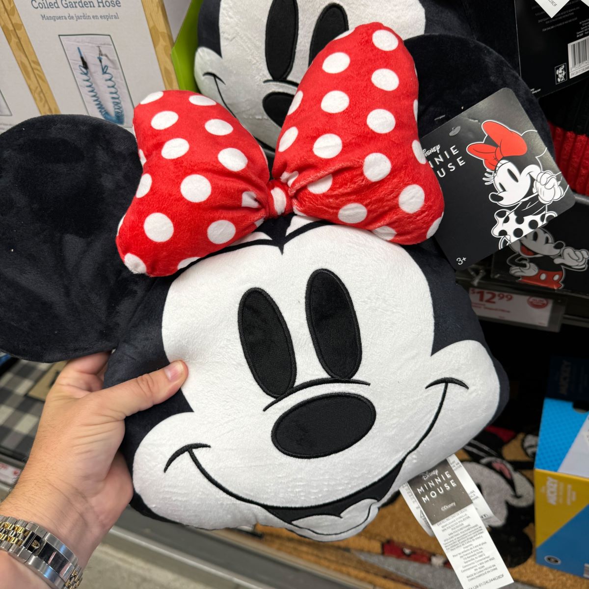 hand holding a Minnie Mouse pillow
