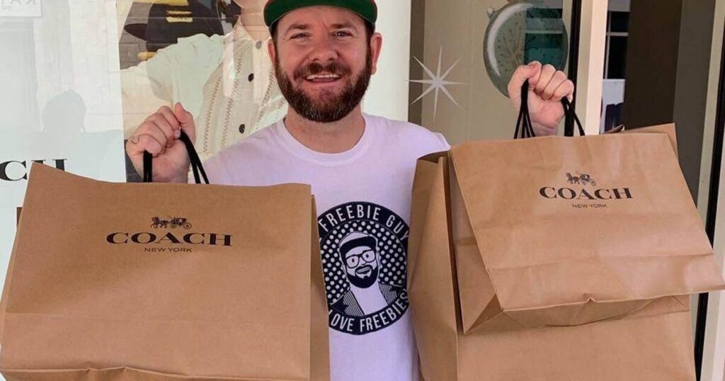 man holding two Coach bags