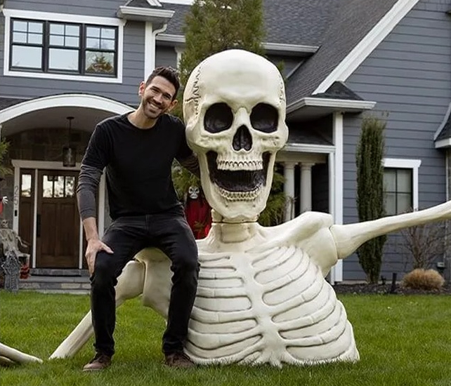 Giant Rattles the Groundbreaking Skeleton man sitting on a large skeleton Halloween prop