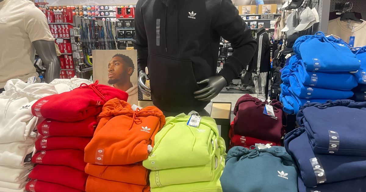 display of adidas hoodies on a table