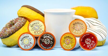 k-cup pods by a cup of coffee and donuts