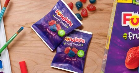 two packs of fruit snacks next to the box of fruit snacks