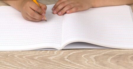 kid writing in a notebook