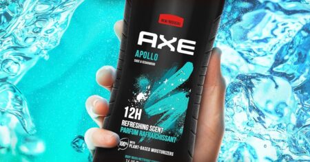 hand holding a bottle of Axe body wash