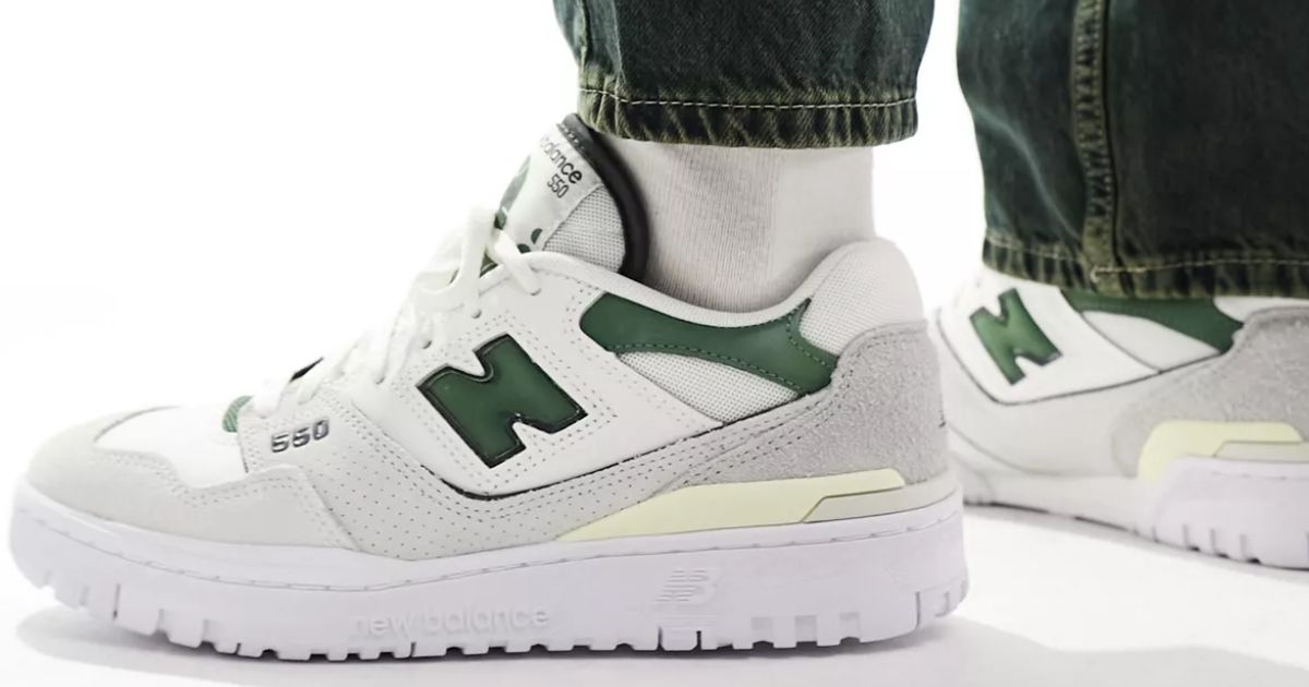 person wearing white and green New Balance 550 sneakers