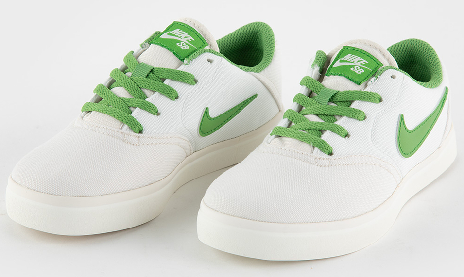 white Nike sneaker with green logo and laces