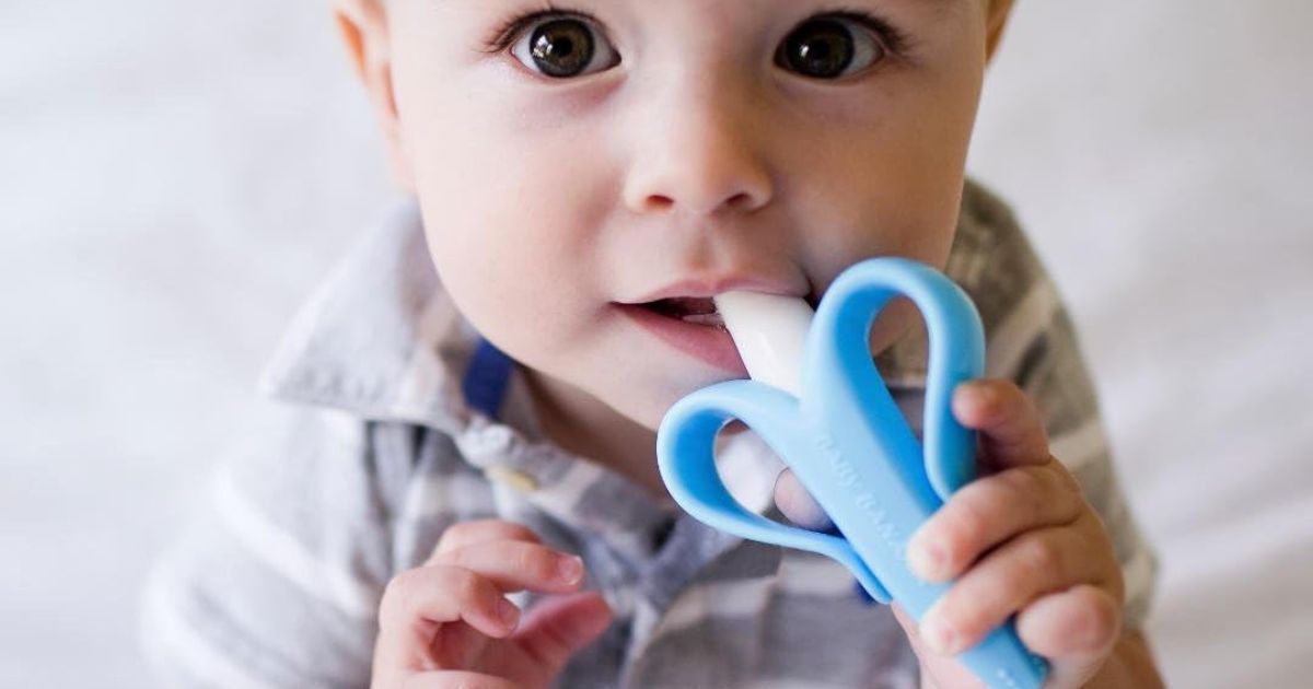 Banana Toothbrush baby holding a toothbrush