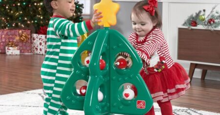 kids playing with a toy Christmas tree