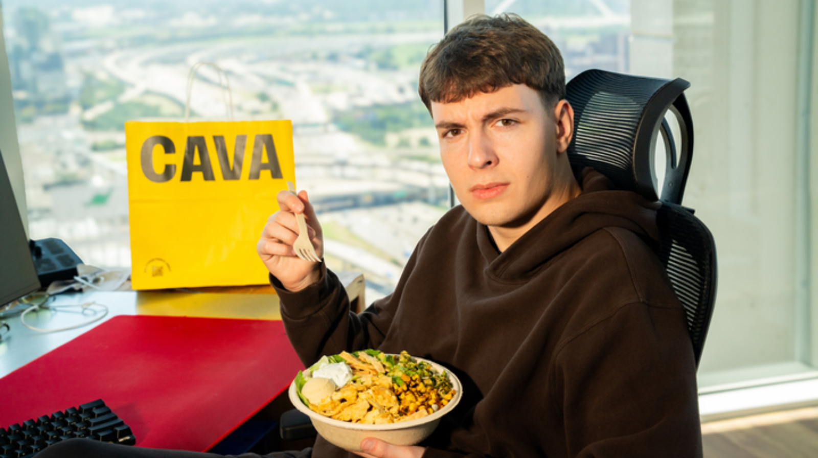Cava x Clix holding a Clix Chicken Shawarma Bowl