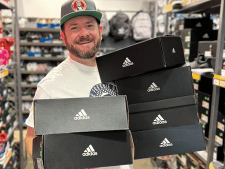 Kendall holding Adidas Sneakers in store