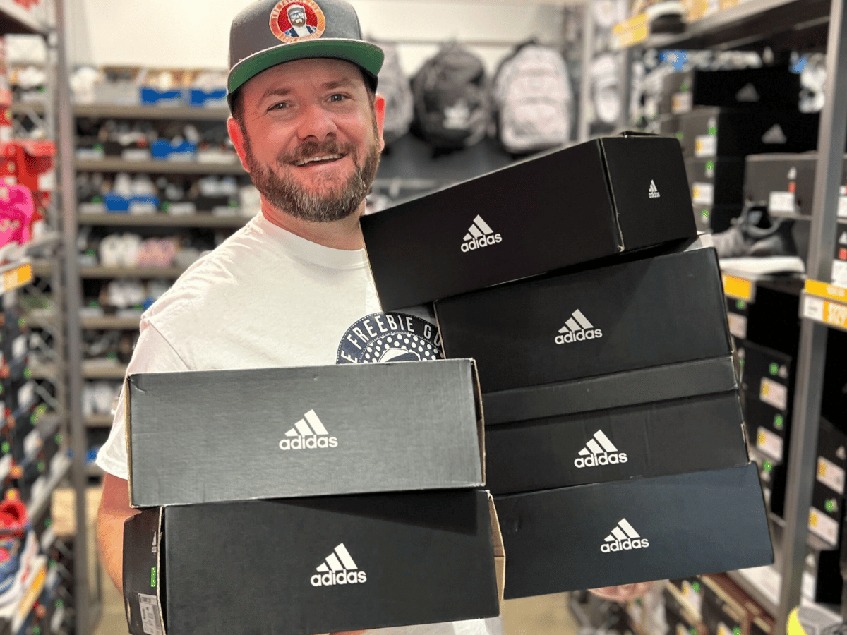 Kendall holding Adidas Sneakers in store