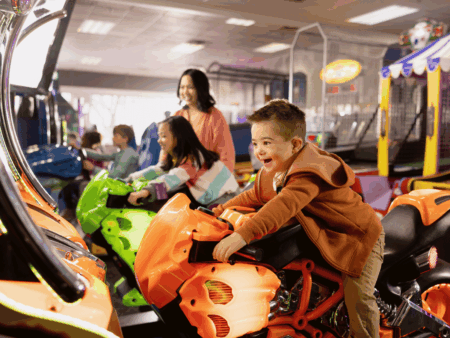 Chuck E Cheese Kids playing on arcades