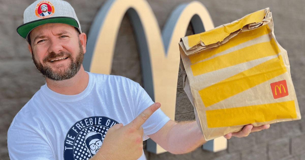 man holding Mcdonalds bag full of food deals and freebies